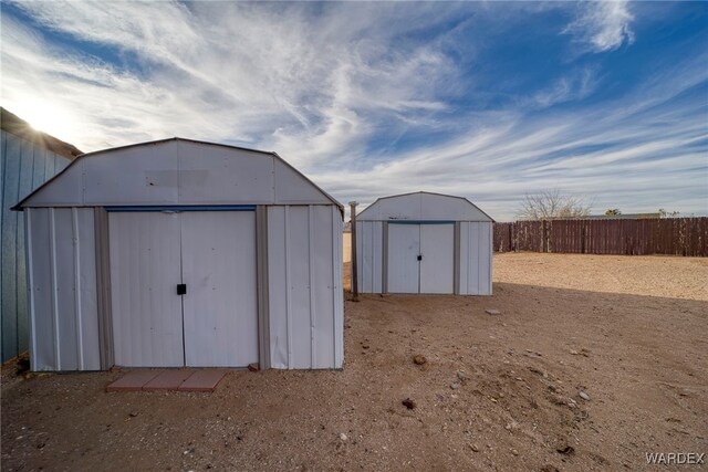 view of shed with fence