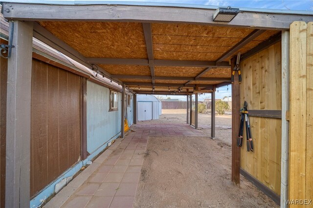 view of parking / parking lot with a storage unit