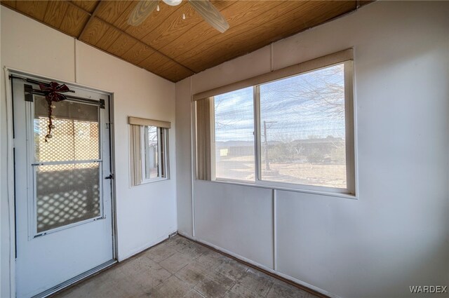 empty room with ceiling fan, lofted ceiling, and wood ceiling