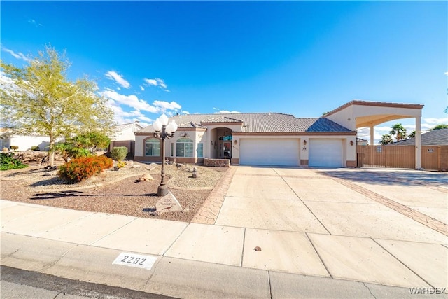 view of front of home with a garage, a tiled roof, concrete driveway, and stucco siding