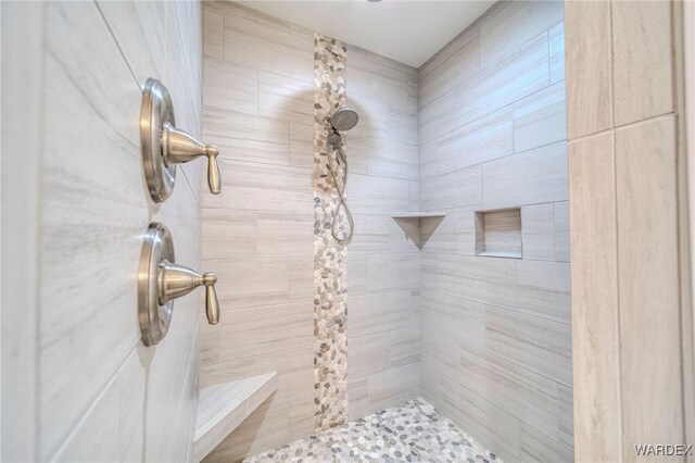 bathroom featuring tiled shower