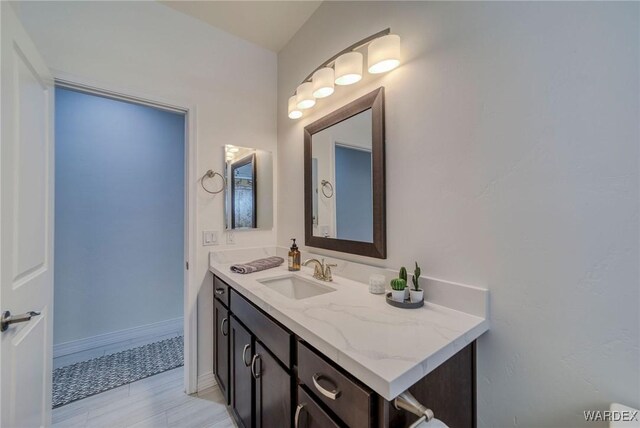 bathroom with baseboards and vanity