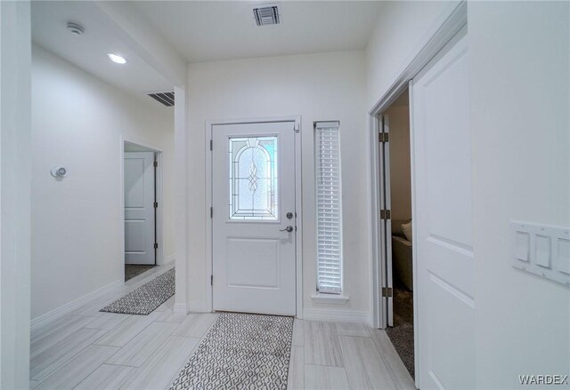 foyer with visible vents and baseboards