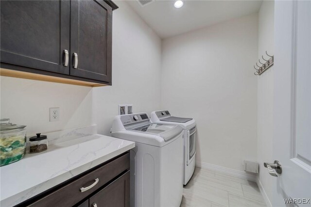 clothes washing area featuring cabinet space, visible vents, baseboards, washer and dryer, and recessed lighting