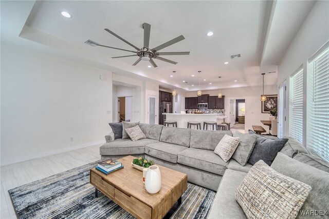 living room featuring recessed lighting, visible vents, and baseboards