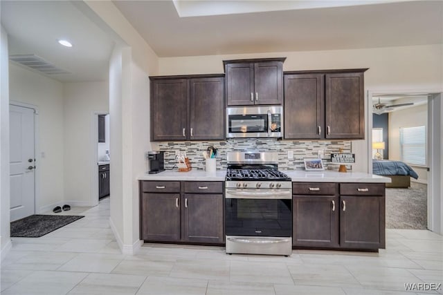 kitchen featuring dark brown cabinetry, visible vents, stainless steel appliances, and light countertops