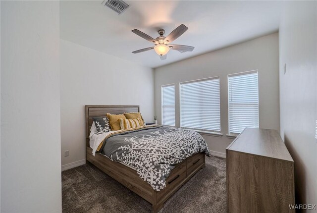 bedroom with dark colored carpet, visible vents, and baseboards