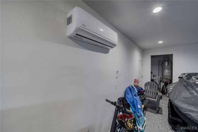 interior space with recessed lighting, gas water heater, and a wall unit AC