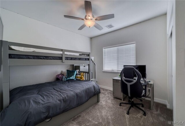 carpeted bedroom featuring ceiling fan, visible vents, and baseboards