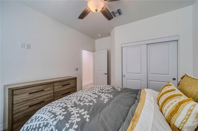 bedroom featuring a closet, visible vents, and a ceiling fan