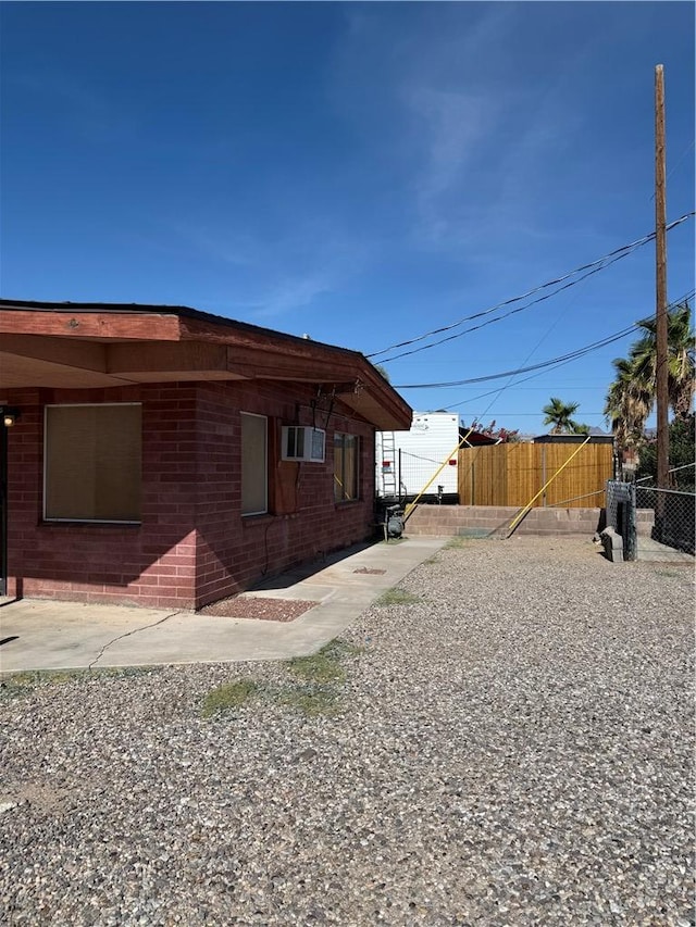2135 3rd St, Bullhead City, AZ 86429 - view of home's exterior with a wall unit AC