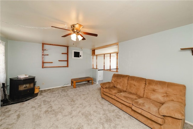 3345 W Smith Dr, Golden Valley, AZ 86413 - living area with a wood stove, ceiling fan, carpet, and baseboards