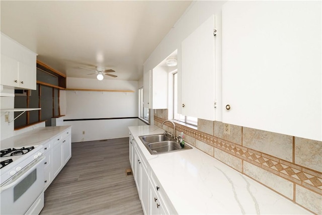 3345 W Smith Dr, Golden Valley, AZ 86413 - kitchen featuring a sink, white range with gas stovetop, a ceiling fan, and white cabinetry
