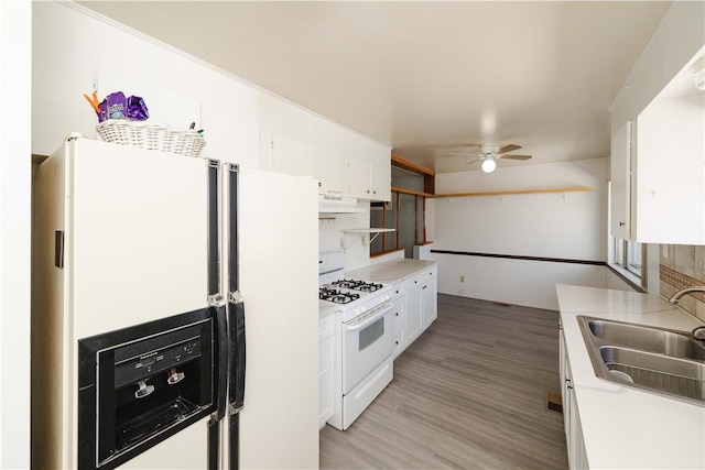 3345 W Smith Dr, Golden Valley, AZ 86413 - kitchen with white appliances, a sink, under cabinet range hood, white cabinetry, and a ceiling fan