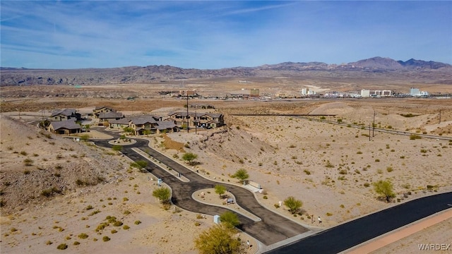 drone / aerial view featuring a mountain view, view of desert, and a rural view