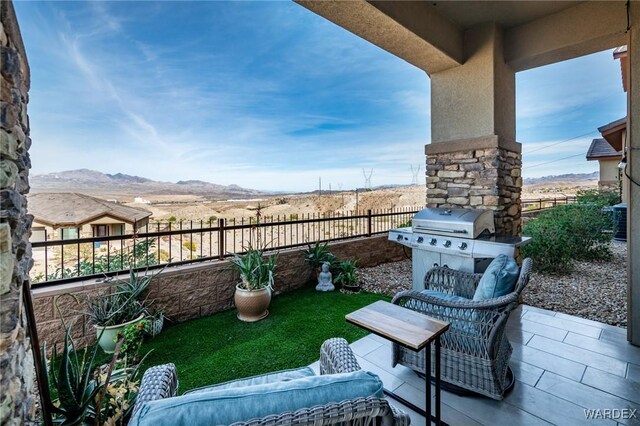 balcony with a patio, a mountain view, and area for grilling