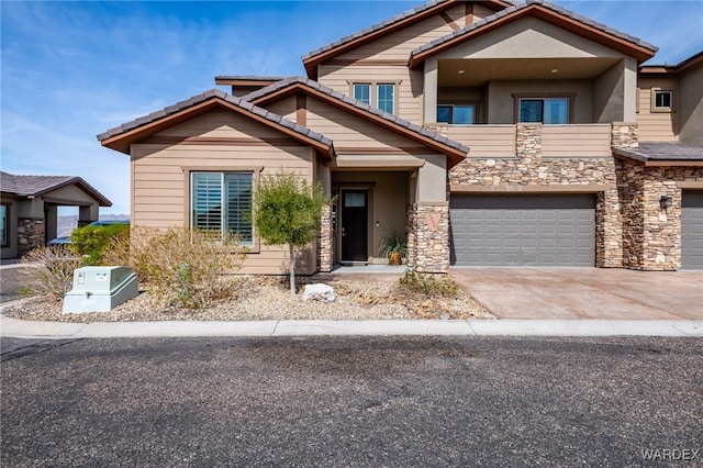 craftsman house with stone siding, a garage, stucco siding, concrete driveway, and a tiled roof