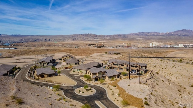 aerial view featuring a residential view, a mountain view, and view of desert