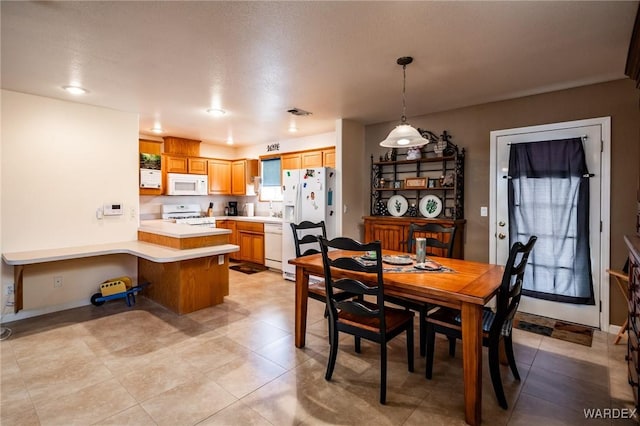 dining area featuring baseboards and visible vents