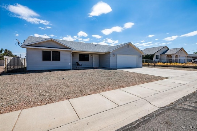 ranch-style home featuring driveway, an attached garage, and fence