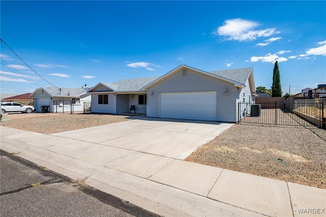 ranch-style house featuring an attached garage, central air condition unit, fence, and concrete driveway