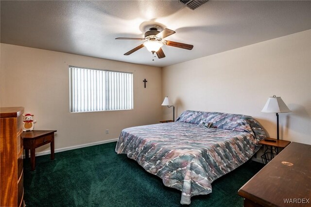 bedroom with ceiling fan, dark carpet, visible vents, and baseboards