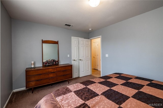 bedroom featuring visible vents, dark carpet, and baseboards