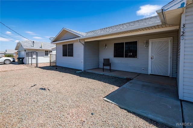 rear view of house with a patio area and fence