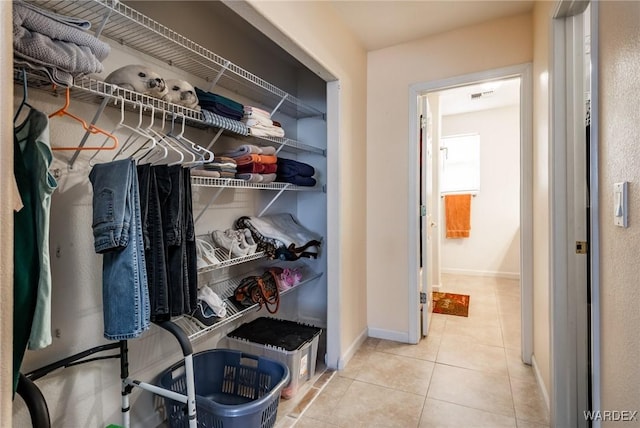 walk in closet with light tile patterned floors and visible vents