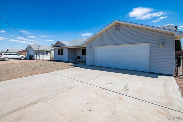 ranch-style house with a garage and driveway