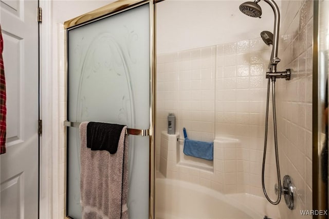 bathroom with bath / shower combo with glass door