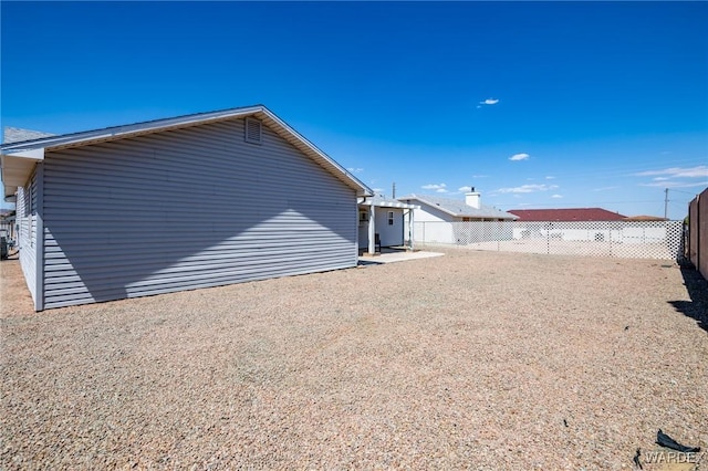 back of house with a patio and fence