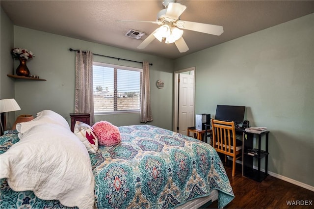 bedroom featuring dark wood-style floors, baseboards, visible vents, and ceiling fan