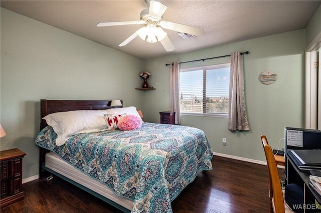 bedroom featuring dark wood-style floors, visible vents, baseboards, and ceiling fan