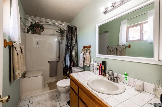 bathroom featuring a textured ceiling, curtained shower, toilet, vanity, and tile patterned floors