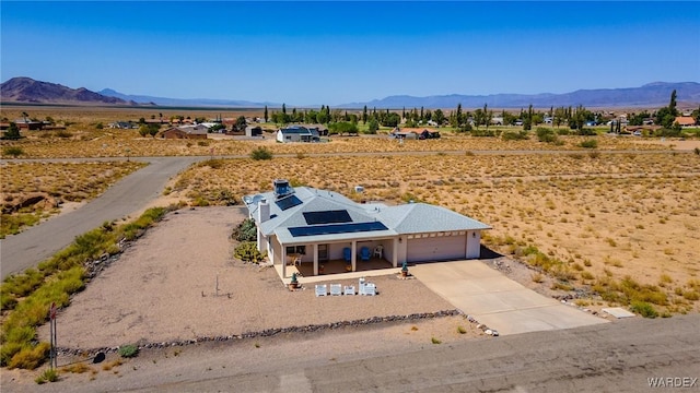 birds eye view of property with a mountain view