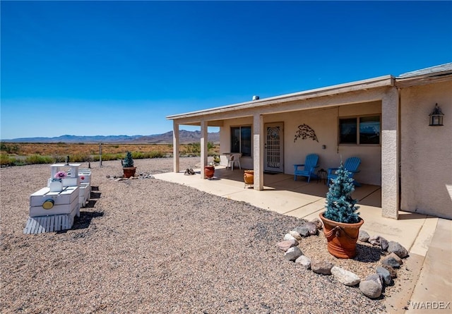 exterior space featuring a mountain view and a patio