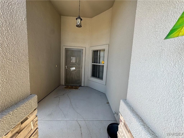 doorway to property with stucco siding