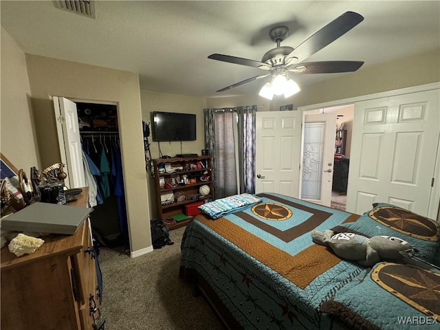 bedroom featuring a closet, a spacious closet, carpet flooring, visible vents, and ceiling fan