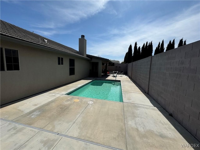 view of pool featuring a patio area, a fenced backyard, and a fenced in pool