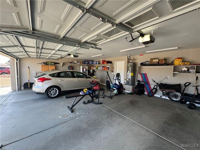 garage featuring water heater and a garage door opener