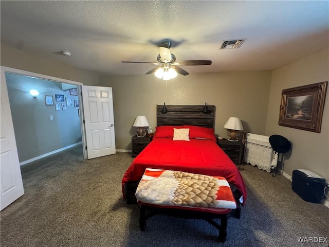 bedroom featuring visible vents, baseboards, carpet flooring, and a textured ceiling
