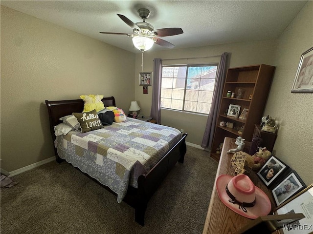 carpeted bedroom featuring baseboards, ceiling fan, a textured wall, and a textured ceiling