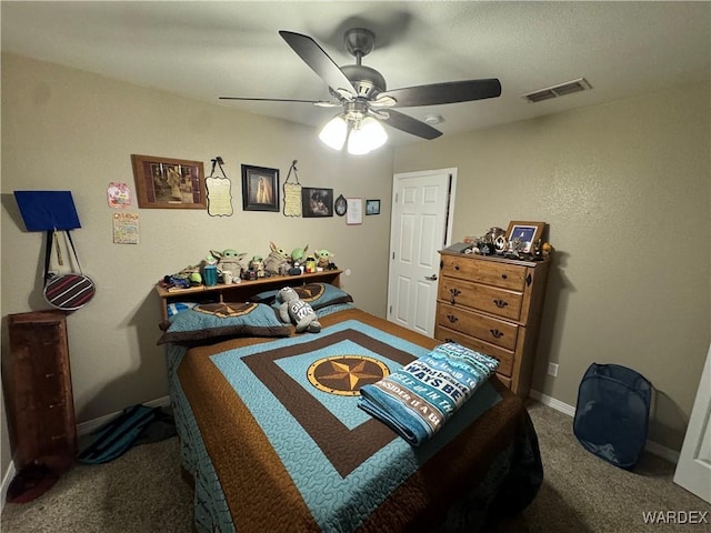 carpeted bedroom with baseboards, a ceiling fan, and visible vents