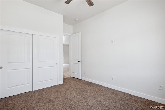 unfurnished bedroom featuring a closet, carpet flooring, ceiling fan, and baseboards