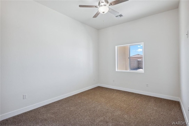 empty room with visible vents, carpet flooring, a ceiling fan, and baseboards