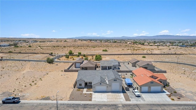 aerial view featuring a residential view, a desert view, and a mountain view