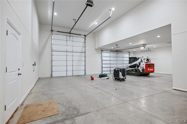 garage with recessed lighting and baseboards