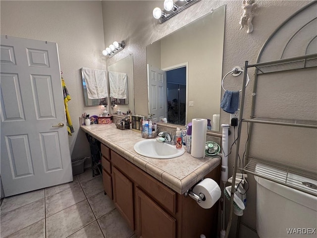 1481 E Topaz Cir Unit 2, Fort Mohave, AZ 86426 - bathroom with tile patterned floors, vanity, and a textured wall