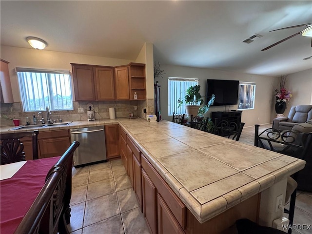 1481 E Topaz Cir Unit 2, Fort Mohave, AZ 86426 - kitchen featuring a sink, open floor plan, stainless steel dishwasher, visible vents, and tile countertops